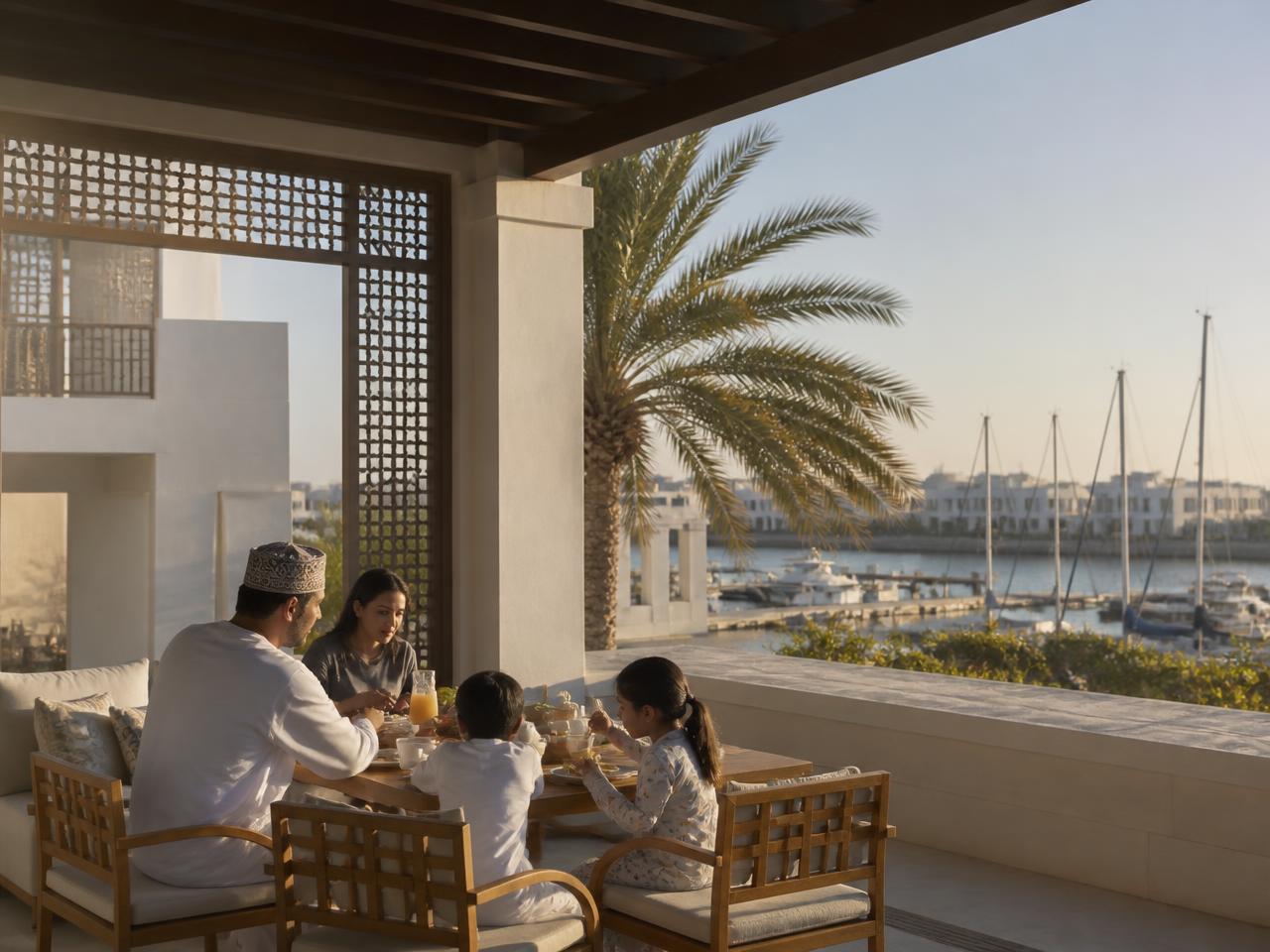 A family having breakfast on a shaded terrace above the marina